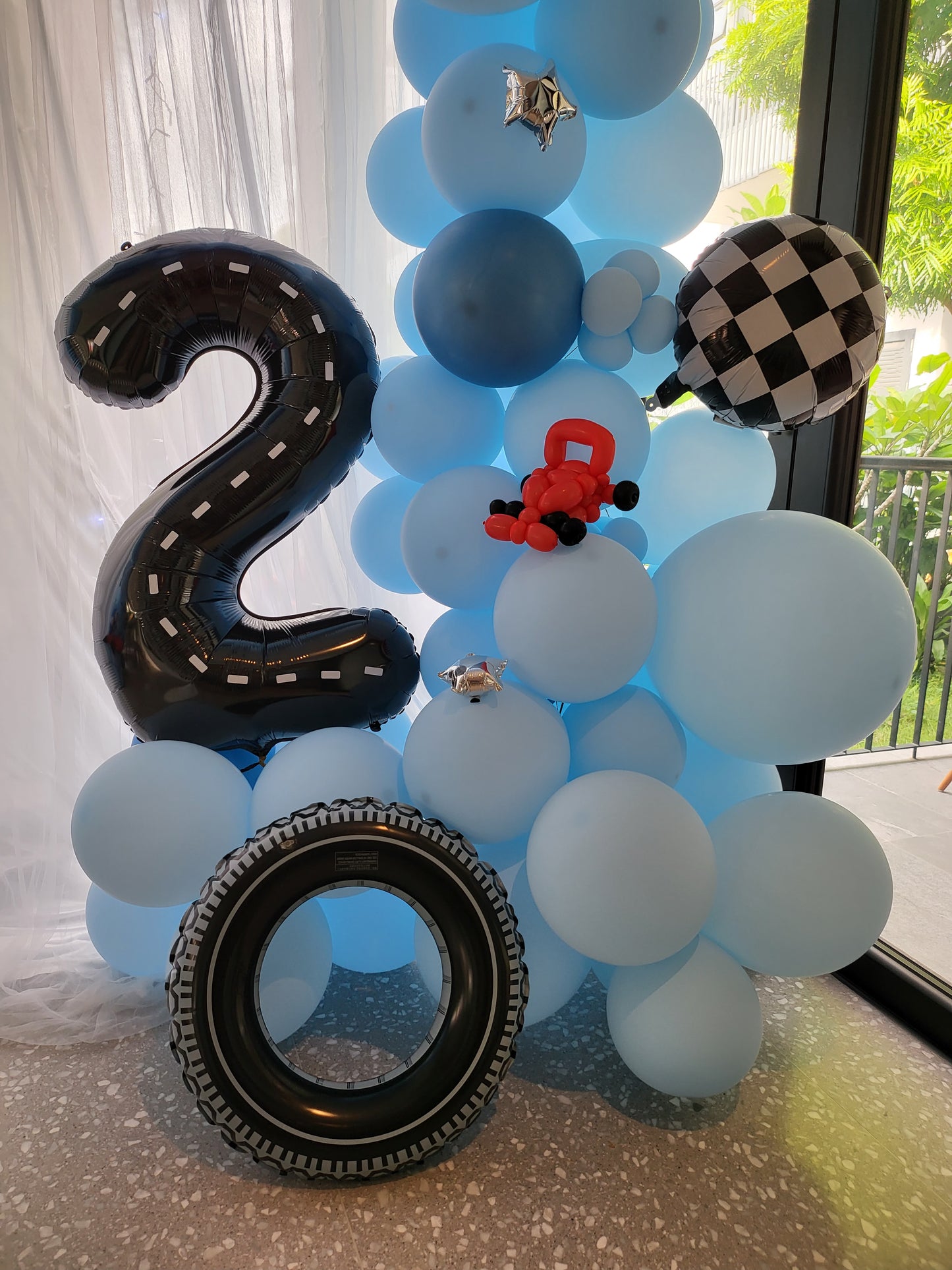 Curtain backdrop balloon garland with custom sculpture close-up