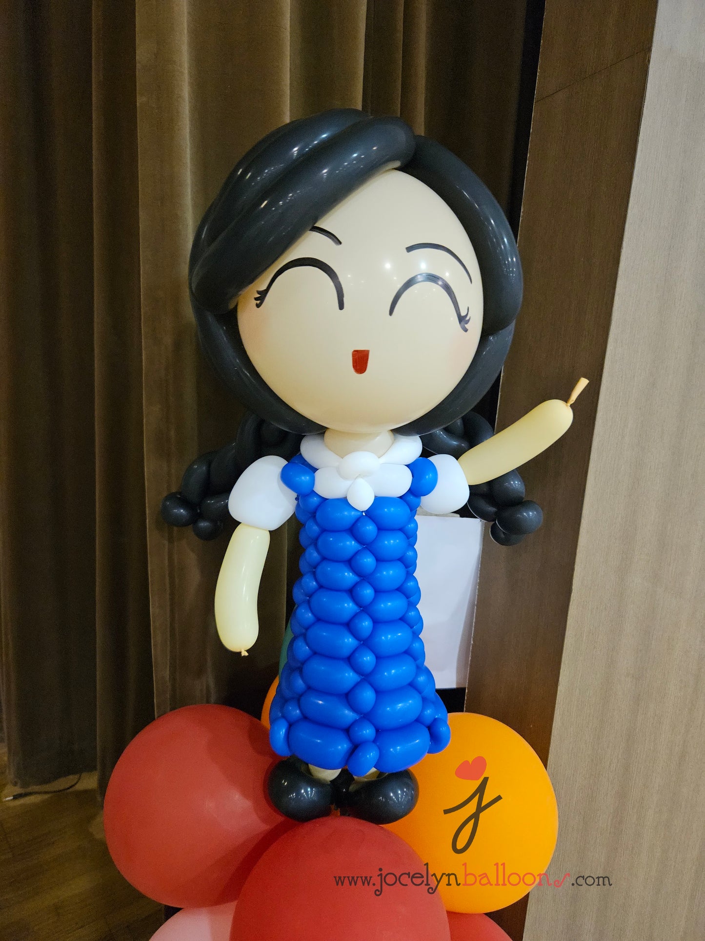 A Pair of Balloon Columns with Balloon Sculpture School Boy & School Girl