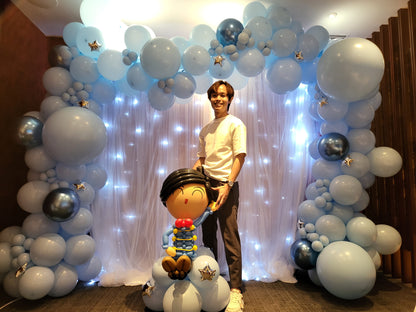 Curtain backdrop with fairy lights and pastel blue balloon garland