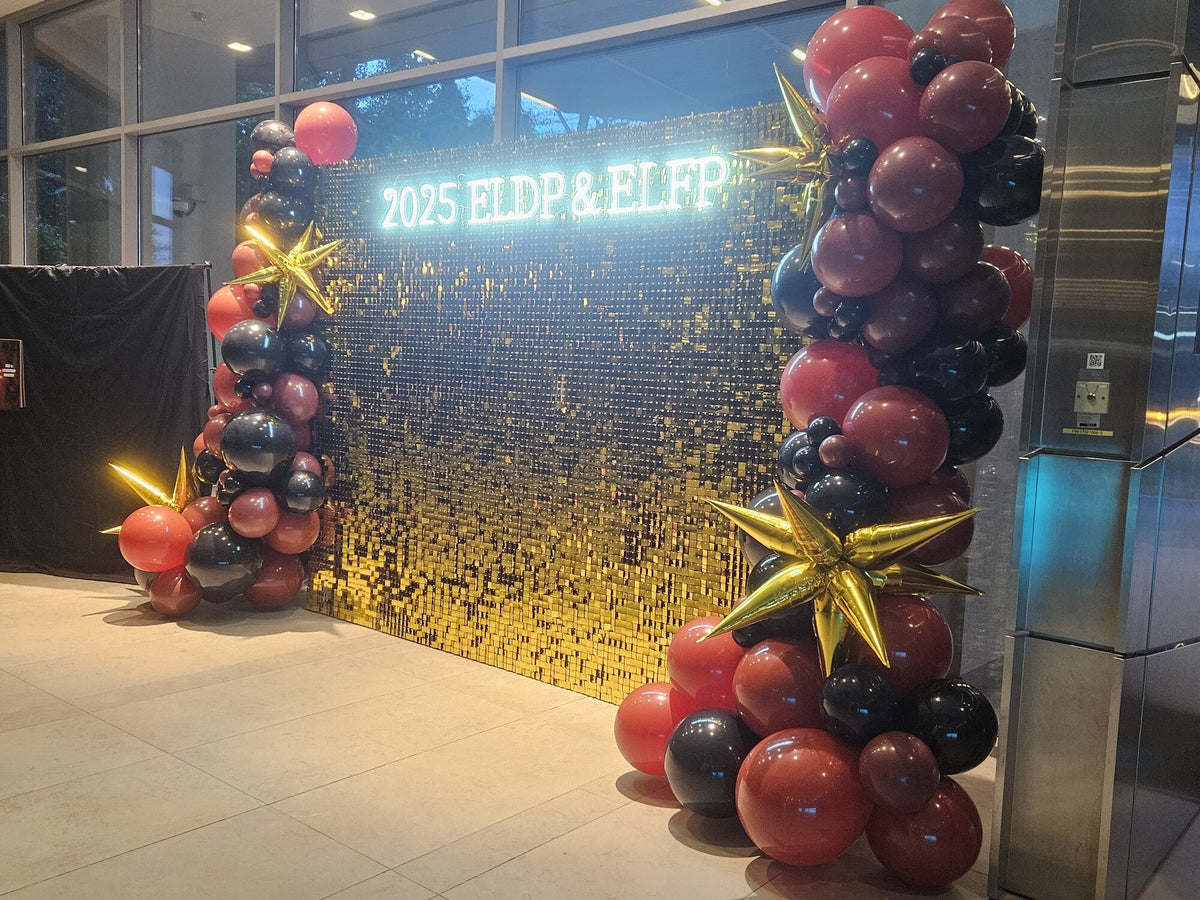 Gold shimmer wall with balloon columns for corporate event, Singapore