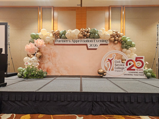 Grand 5m customised foamboard balloon backdrop for a corporate appreciation evening, with sage, cream and gold organic garland and flower decor, by BalloonClub Singapore