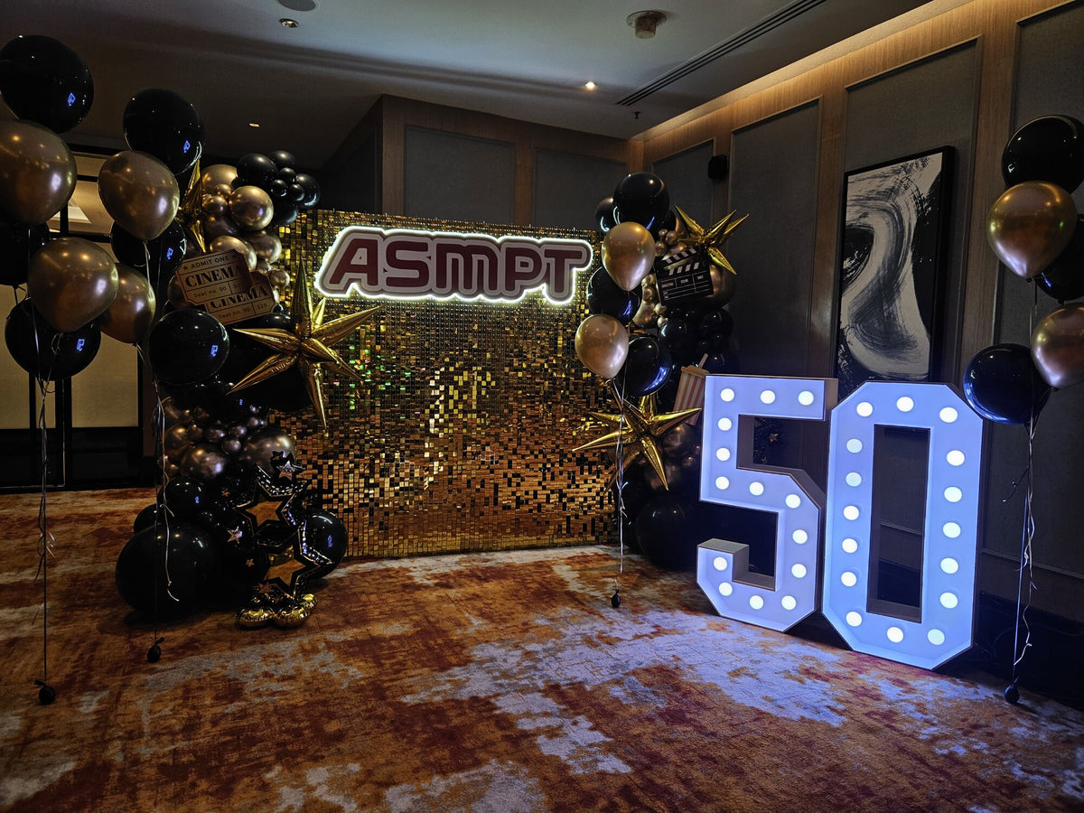 ASMPT 50th anniversary gold shimmer backdrop with black and gold balloons and LED 50, Singapore