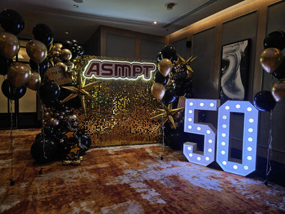 ASMPT 50th anniversary gold shimmer backdrop with black and gold balloons and LED 50, Singapore