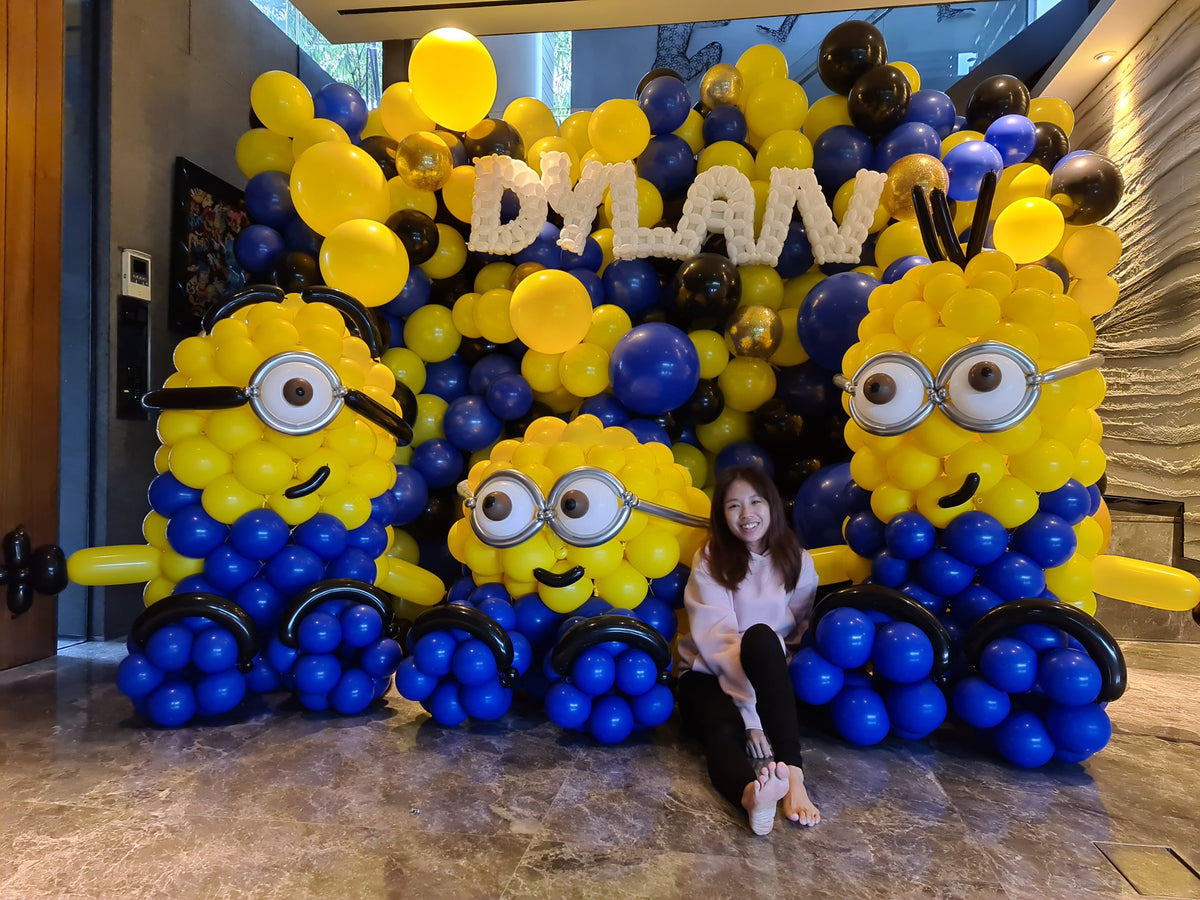 Full balloon backdrop with three large custom balloon sculptures and twisted balloon name