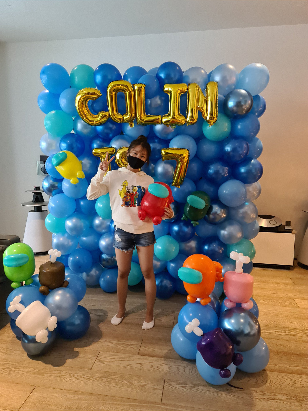 Themed full balloon backdrop with small sculpted balloon characters and name, BalloonClub Singapore