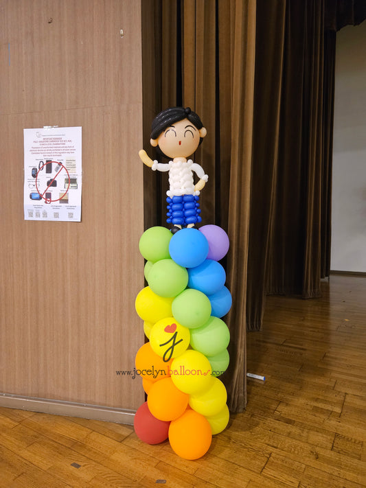 A Pair of Balloon Columns with Balloon Sculpture School Boy & School Girl