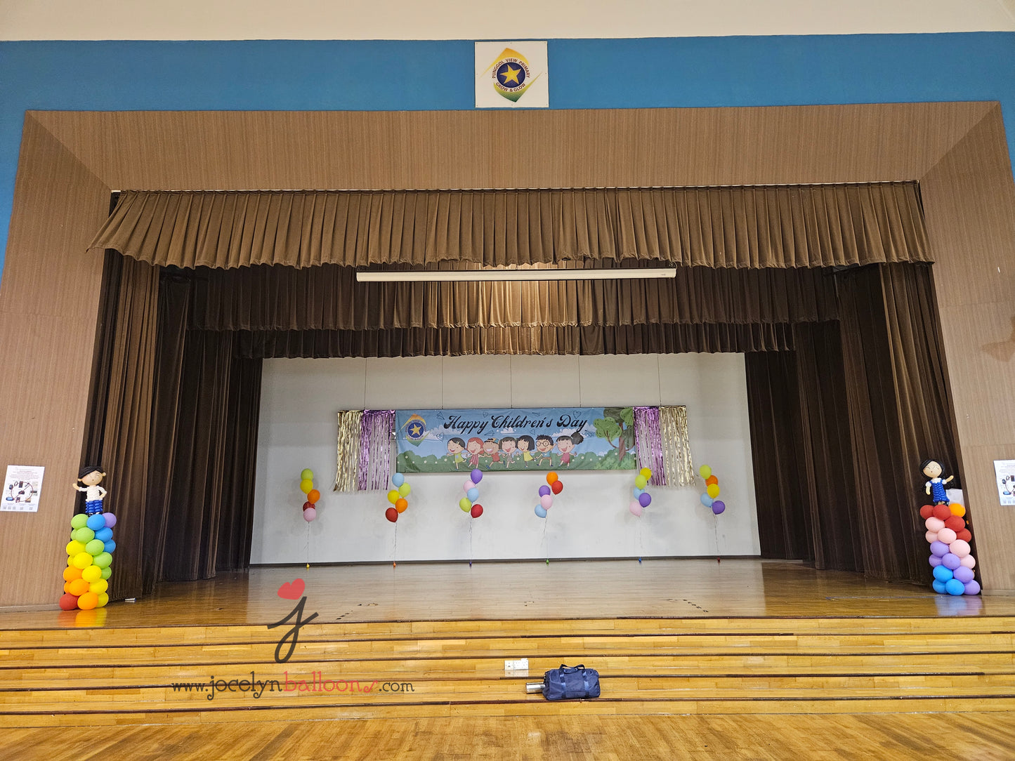 A Pair of Balloon Columns with Balloon Sculpture School Boy & School Girl