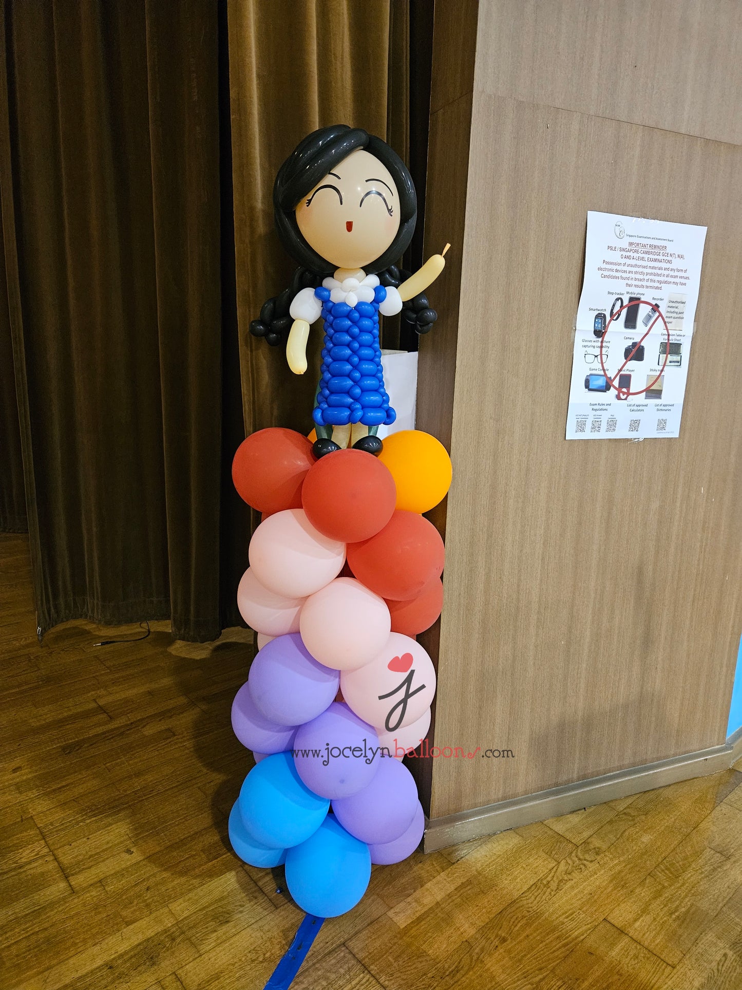 A Pair of Balloon Columns with Balloon Sculpture School Boy & School Girl