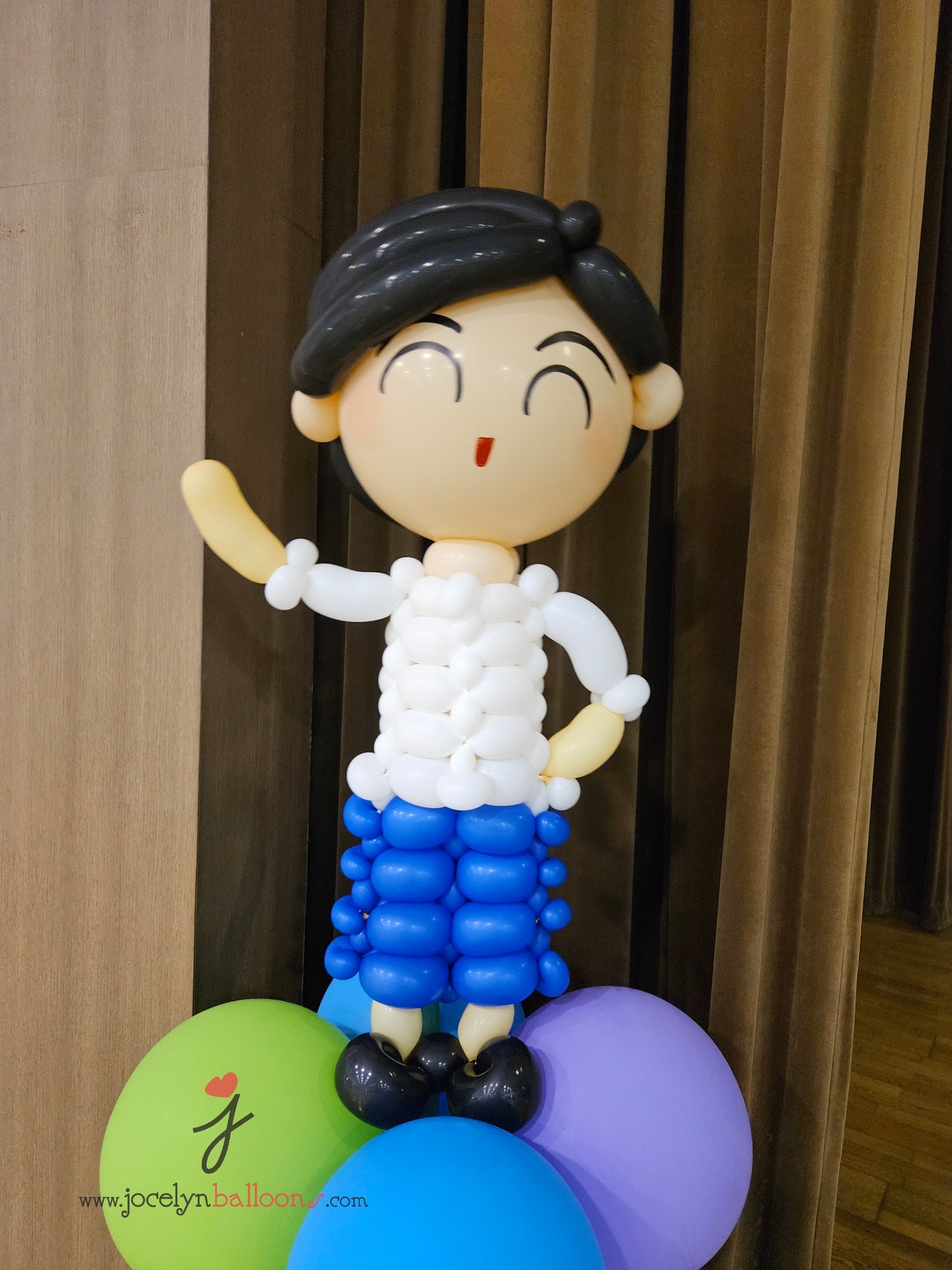 A Pair of Balloon Columns with Balloon Sculpture School Boy & School Girl